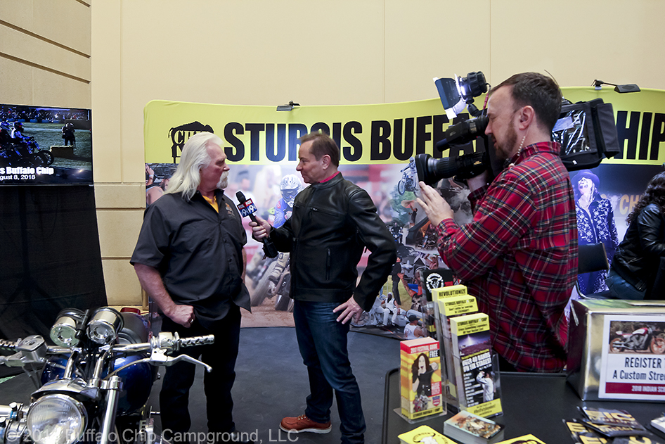 Crazy John Markwald interview with local media in the Sturgis Buffalo Chip display