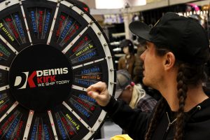 Show attendee tries his luck spinning the prize wheel in the Dennis Kirk booth at the 2019 Donnie Smith Bike & Car Show