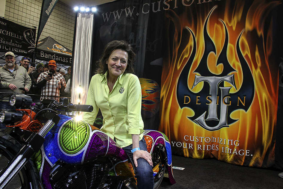 Lizzy Hilgers sits on top of the custom Harley unveiled in the TJ Designs display at the Donnie Smith Bike and Car Show